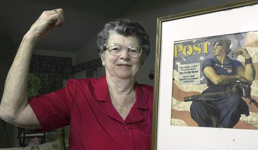 FILE - In this May 22, 2002 file photo, Mary Doyle Keefe poses at her home in Nashua, N.H., with the May 29, 1943, cover of the Saturday Evening Post for which she had modeled as "Rosie the Riveter" in a Norman Rockwell painting. Keefe died Tuesday, April 21, 2015, in Simsbury, Conn., after a brief illness. She was 92. (AP Photo/Jim Cole, File)