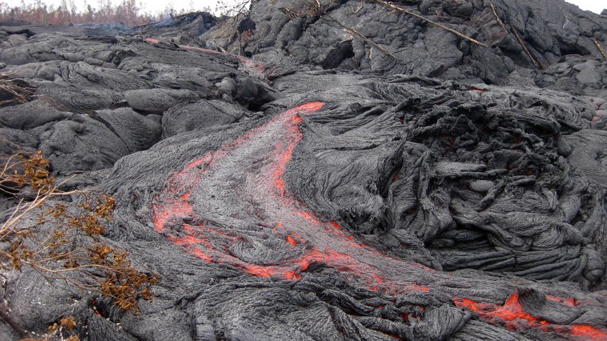 ADVANCE FOR USE SUNDAY, APRIL 26, 2015, AND THEREAFTER- FILE - This Jan. 26, 2015 file photo released by the U.S. Geological Survey shows one of many small breakouts of lava in the Puna region near Pahoa, Hawaii. There was a silver lining in the lava flow emergency that threatened Puna over the past months — an unexpected financial boost for local contractors large and small. (AP Photo/U.S. Geological Survey, File)