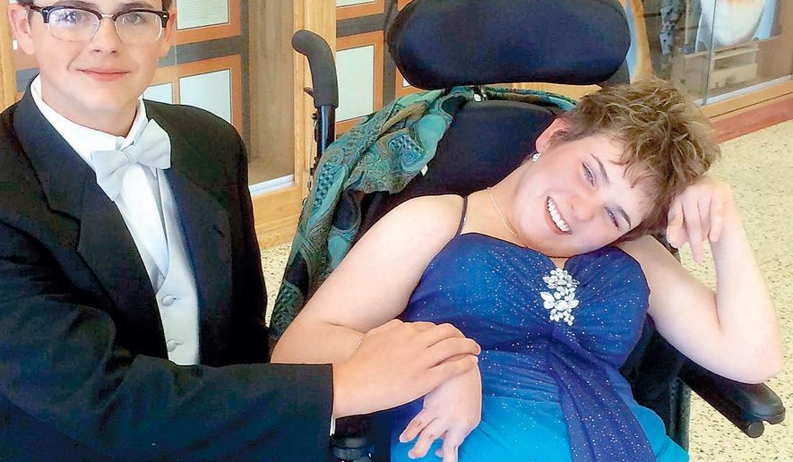Caprock High School senior Liberty Jennings, right, poses her date, Jake Clements, left, on April 14, 2015 in Amarillo, Texas. Jennings, suffers from debilitating Lyme disease, fulfilled one of her dreams when accepted an invitation from Jake Clements, left to go to the prom. (Jon Mark Beilue/The Amarillo Globe News via AP)