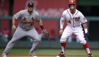 Washington Nationals&#39; Bryce Harper, right, takes a lead off of first base while blowing a bubble as St. Louis Cardinals first baseman Matt Adams, left, looks on during the first inning of a baseball game, Thursday, April 23, 2015, in Washington. (AP Photo/Nick Wass)