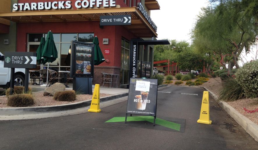 A Starbucks store closes Friday, April 24, 2015, in Phoenix because of computer issues. Starbucks says a sales register computer glitch has disrupted sales at company-operated stores in the United States and Canada. The company apologized to customers for the inconvenience late Friday and said it was working to resolve the outage. Customers found some stores closed and others offering free coffee. (AP Photo/Traci Carl)