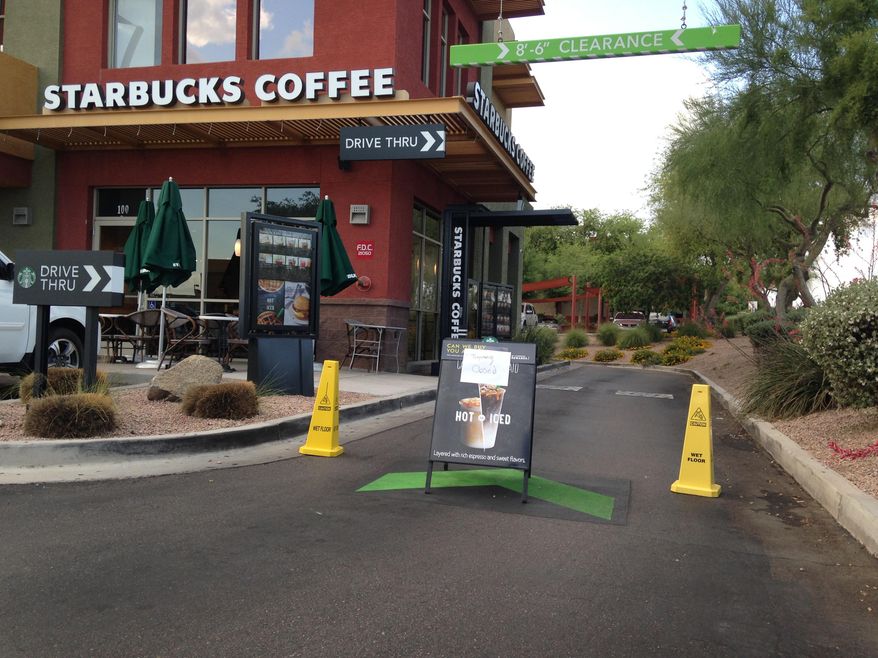 A Starbucks store closes Friday, April 24, 2015, in Phoenix because of computer issues. Starbucks says a sales register computer glitch has disrupted sales at company-operated stores in the United States and Canada. The company apologized to customers for the inconvenience late Friday and said it was working to resolve the outage. Customers found some stores closed and others offering free coffee. (AP Photo/Traci Carl)