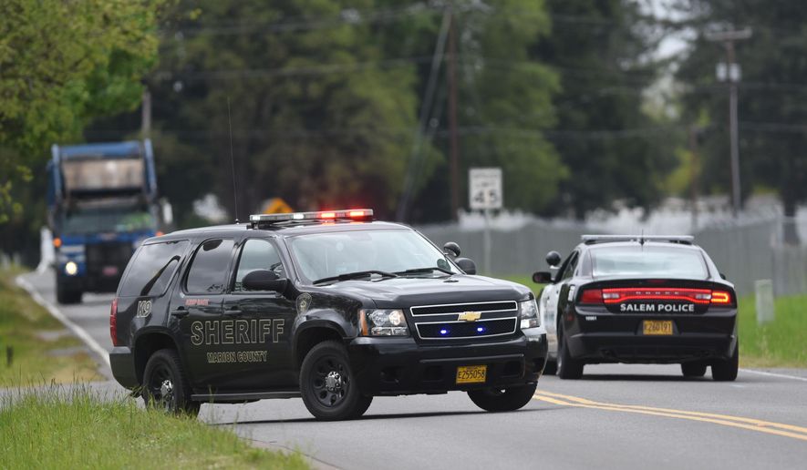 Police block off a portion of Turner Road in Salem, Ore., as they pursue an active shooter on Friday, April 24, 2015. (Danielle Peterson/Statesman-Journal via AP)