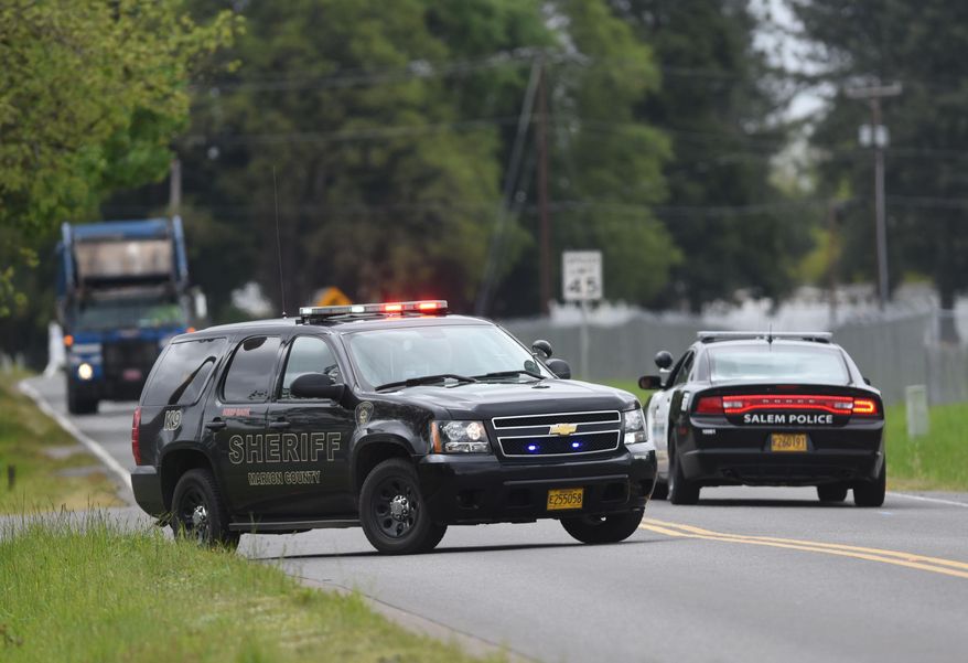 Police block off a portion of Turner Road in Salem, Ore., as they pursue an active shooter on Friday, April 24, 2015. (Danielle Peterson/Statesman-Journal via AP)