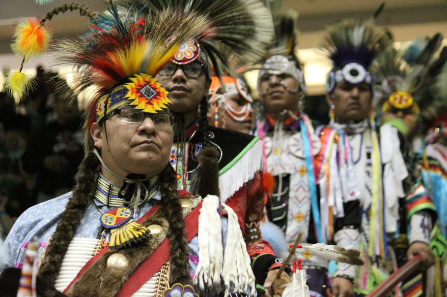 Native American and indigenous dancers wait their turn to join the procession during the grand entrance at the 32nd annual Gathering of Nations in Albuquerque N.M., on Friday, April 24, 2015. The three-day event is North America's largest powwow, attracting indigenous dancers, drummers and singers from across the U.S. and Canada. (AP Photo/Susan Montoya Bryan)