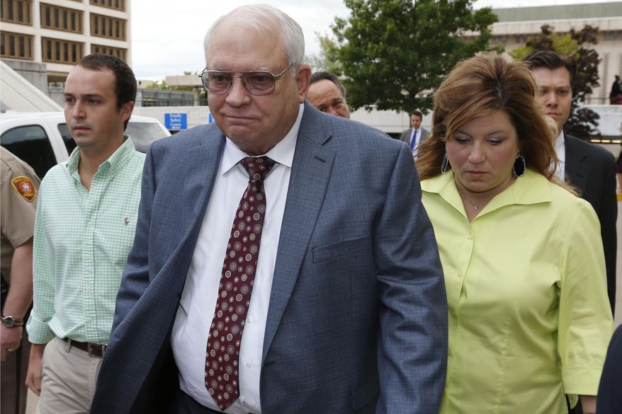 File - In this April 21, 2015 file photo, Robert Bates, second from right, leaves his arraignment in Tulsa, Okla. Bates, a 73-year-old Tulsa County reserve deputy, fatally shot a suspect who was pinned down by officers. Attorneys for the man killed have released a report that says Bates didn’t receive special treatment for admittance into the advanced deputy program, but that he did receive special treatment once admitted. With Bates are his daughter, Leslie McCreary, right, and an unidentified grandson, left. (AP Photo/Sue Ogrocki, File)
