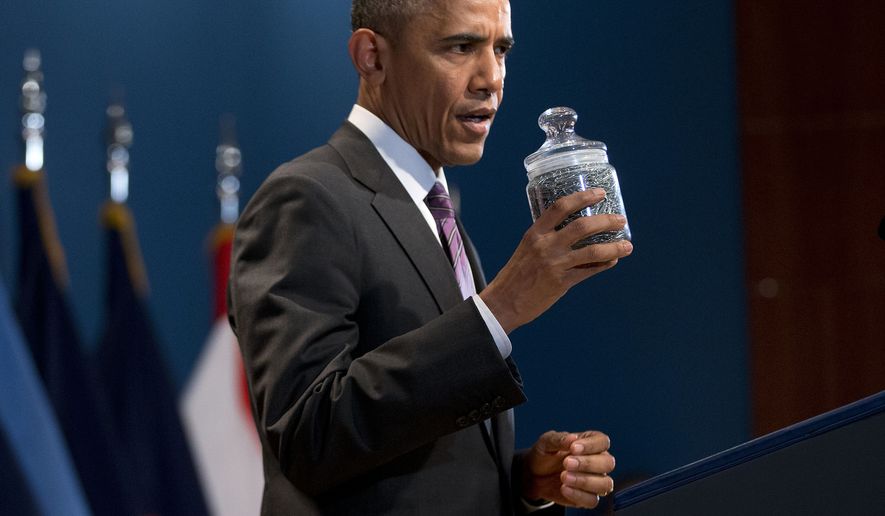 President Barack Obama holds up a jar full of paper clips while speaking at the Office of the Director of National Intelligence&#39;s (ODNI) 10th anniversary at ODNI headquarters in McLean, Va., Friday, April 24, 2015. Obama was making a joke about Director of National Intelligence James R. Clapper and used the jar to help illustrated the point. (AP Photo/Pablo Martinez Monsivais)