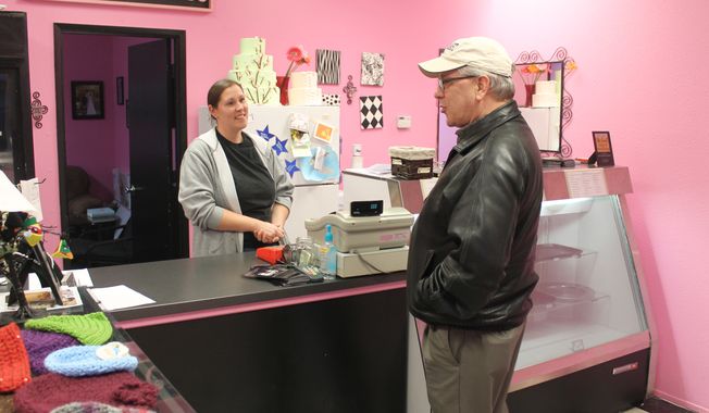 Melissa Klein, co-owner of Sweet Cakes by Melissa in Gresham,Ore., tells a customer  that the bakery has sold out of baked goods to sell for the day, Feb. 5, 2013. (Associated Press) ** FILE **