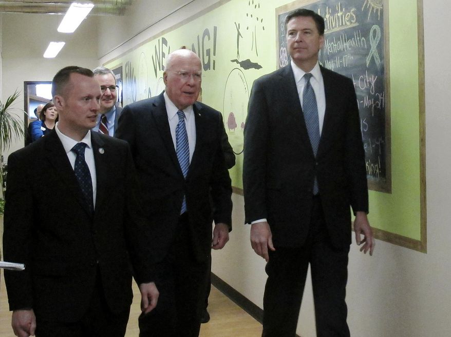 FBI Director James Comey, right, and U.S. Sen. Patrick Leahy, center, tour the Leahy Center for Digital Investigation at Champlain College in Burlington, Vt., on Friday April 24, 2015, with center director Jonathan Rajewski, left. Comey said the FBI needs more people to help fight internet crime. (AP Photo/Wilson Ring)