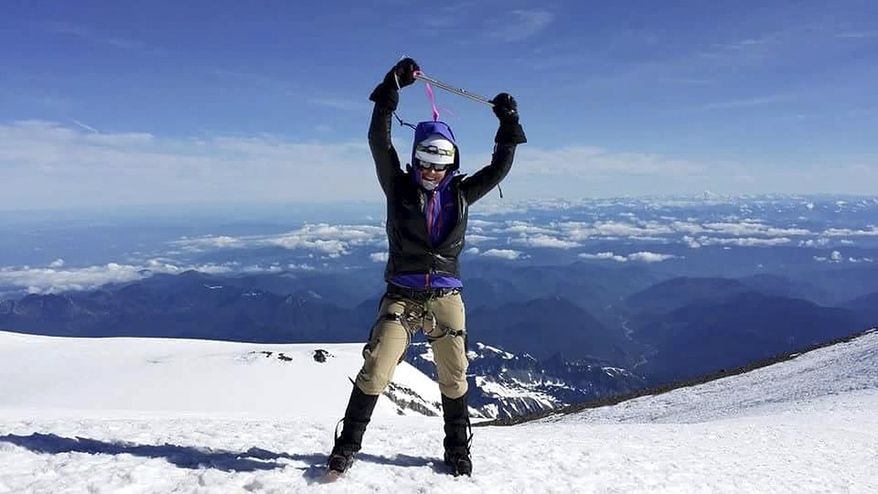 In this July 2014 photo released by Mission Memorial Day and Josh Jespersen, Margaux Mange poses for a photo on Mt. Rainier, Wash. Mange is one of four military veterans who are aiming to summit North America's tallest mountain, Mount McKinley in Alaska, on Memorial Day. (Mission Memorial Day via AP)