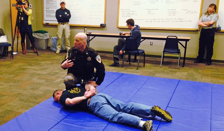 In this April 23, 2015 photo, Dane County Sheriff's Deputy Eric Markgraf demonstrates the steps police are taught to take after shooting someone, during a media training session on police use of force in Waunakee, Wis. The sheriff's department held the training session as a prosecutor to decide whether to charge a white Madison Police officer in the killing of an unarmed biracial man last month. (AP Photo/Todd Richmond)