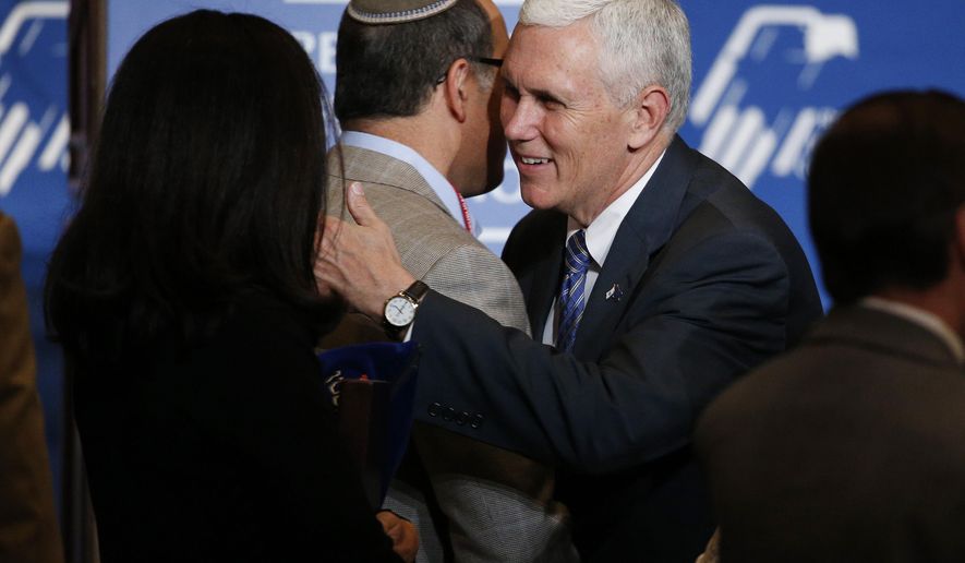 Indiana Gov. Mike Pence, center, meets with people after speaking at the Republican Jewish Coalition spring leadership meeting Saturday, April 25, 2015, in Las Vegas. (AP Photo/John Locher)