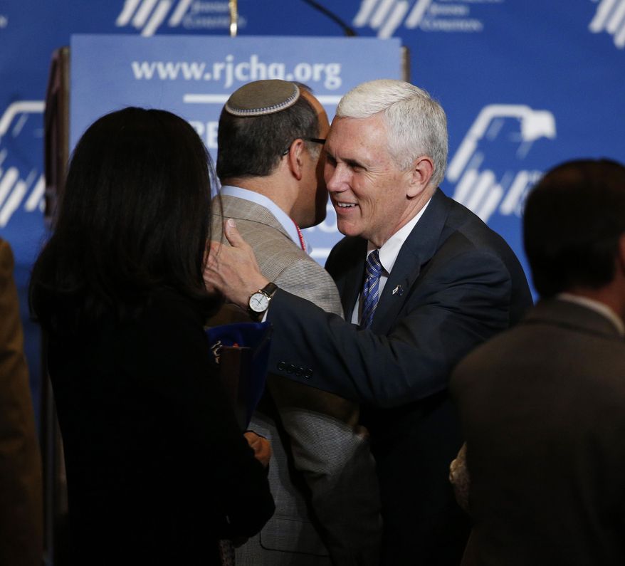 Indiana Gov. Mike Pence, center, meets with people after speaking at the Republican Jewish Coalition spring leadership meeting Saturday, April 25, 2015, in Las Vegas. (AP Photo/John Locher)