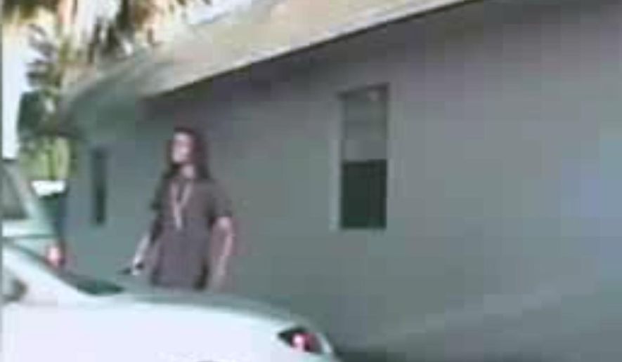This image from dashboard camera video released Thursday April 23, 2015 from Palm Beach County Deputy Adams Lin's cruiser shows Dontrell Stephens seconds before he was shot by Lin. Lin said he saw Stephens reach into his waistband and that he raised a dark object he believed was a gun. The only object shown in the video is the cellphone Stephens had been holding all along. (Palm Beach County Sheriff's Office via AP)