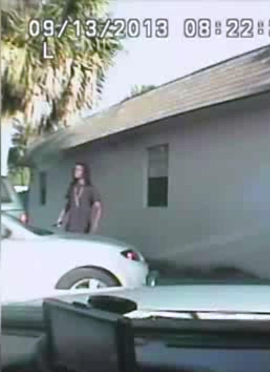 This image from dashboard camera video released Thursday April 23, 2015 from Palm Beach County Deputy Adams Lin's cruiser shows Dontrell Stephens seconds before he was shot by Lin. Lin said he saw Stephens reach into his waistband and that he raised a dark object he believed was a gun. The only object shown in the video is the cellphone Stephens had been holding all along. (Palm Beach County Sheriff's Office via AP)