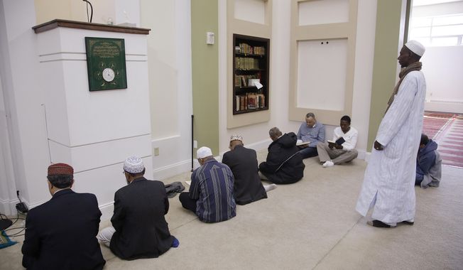 Muslim men gather early before a call to prayers in the mosque at the Islamic Society of Boston Cultural Center Friday, April 24, 2015, in Boston. (Associated Press)