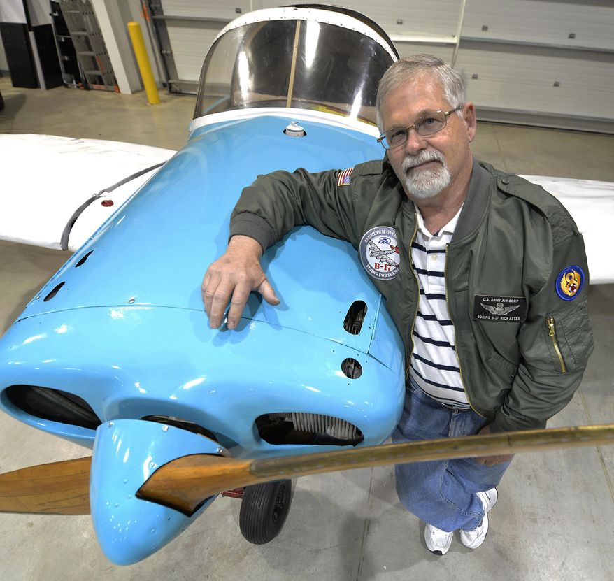 Rick Alter, president of the Experimental Aircraft Association Siouxland Chapter 291, stands with a "parade plane" the association will use to promote private aviation on April 17, 2015 in Sioux City, Iowa. The plane will be used in area parades to help increase the number of people becoming sport pilots. (Tim Hynds/The Sioux City Journal via AP)