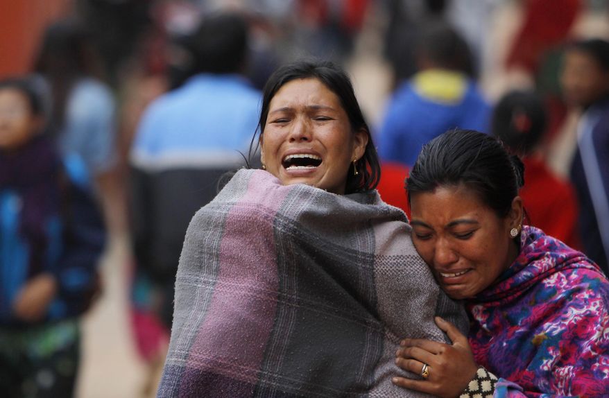 Family members break down during the cremation of an earthquake victim in Bhaktapur near Kathmandu, Nepal, Sunday, April 26, 2015. A strong magnitude 7.8 earthquake shook Nepal's capital and the densely populated Kathmandu Valley before noon Saturday, causing extensive damage with toppled walls and collapsed buildings, officials said. (AP Photo/Niranjan Shrestha)