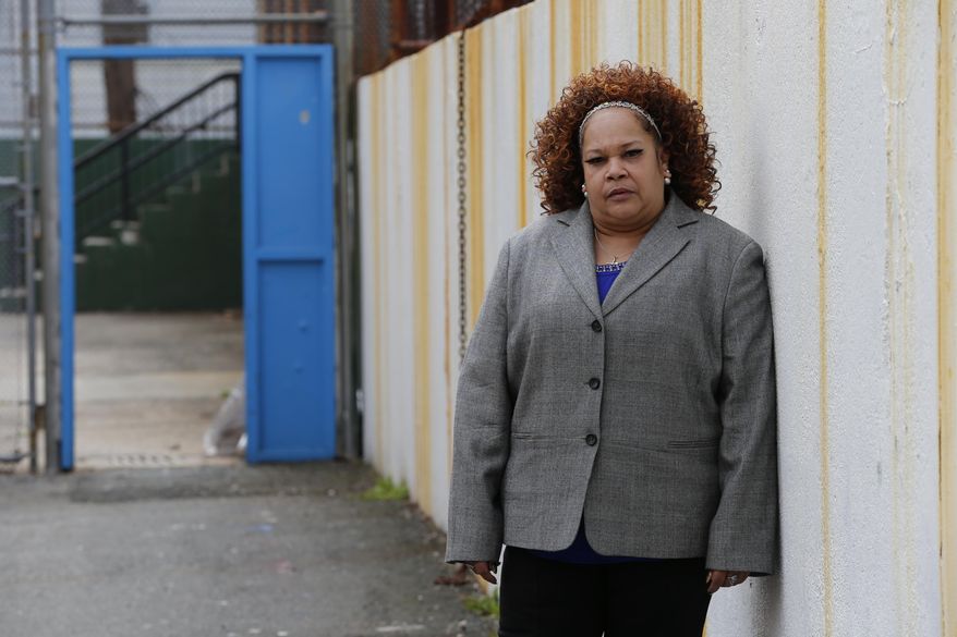 In this Thursday, April 23, 2015, photo Shalga Hightower, mother of Iofemi Hightower, college student slain in 2007, poses for The Associated Press in the schoolyard where the murder happened in Newark, N.J. In the seven-plus years since her college-bound daughter's brutal slaying along with two friends in a case that became a national symbol of urban gun violence, Hightower has been on a mission. It started with a resolve to attend every court hearing involving the six men and boys eventually convicted for the crime, an odyssey that cost her her job and left her family temporarily homeless. Now, a documentary project is aiming to chronicle her struggles and her efforts on behalf of families of crime victims who are too often left to fend for themselves. (AP Photo/Julio Cortez)
