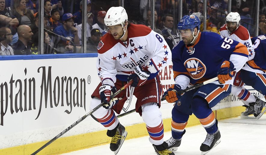 Washington Capitals left wing Alex Ovechkin (8) tries to control the puck against New York Islanders defenseman Johnny Boychuk (55) during the third period in Game 6 in the first round of the NHL hockey Stanley Cup playoffs at Nassau Coliseum on Saturday, April 25, 2015, in Uniondale, N.Y. The best-of-seven games series is tied 3-3. (AP Photo/Kathy Kmonicek)