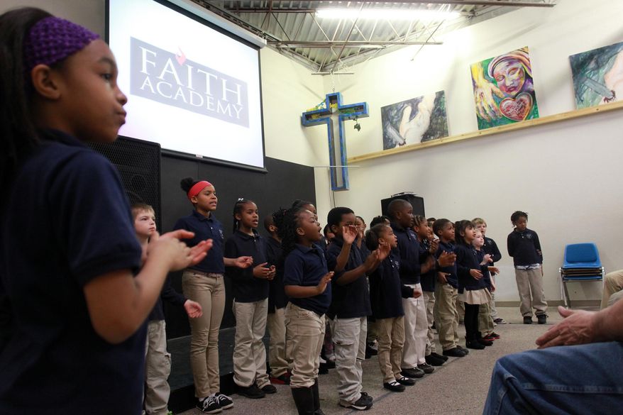 Students at Faith Academy sing to guests at their school on March 31, 2015, in Iowa City, Iowa. The academy, which is in its second academic year after opening in the fall of 2013, currently has three classes of about 10 students each in kindergarten through second grade. (David Scrivner/Iowa City Press-Citizen via AP) NO SALES