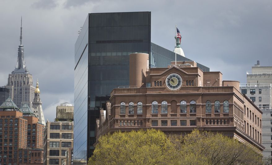 Cooper Union's Foundation Building with its clock tower, one of the tallest in lower Manhattan when it was erected in 1859, rise above tree tops in Cooper Square Park, Thursday, April 23, 2015, in New York. Cooper Union for the Advancement of Science and Art, which produced alumni like Thomas Edison and World Trade Center planner Daniel Libeskind while remaining tuition-free for generations is awaiting the results of a probe that could expose financial mismanagement and tarnish its reputation. (AP Photo/Bebeto Matthews)