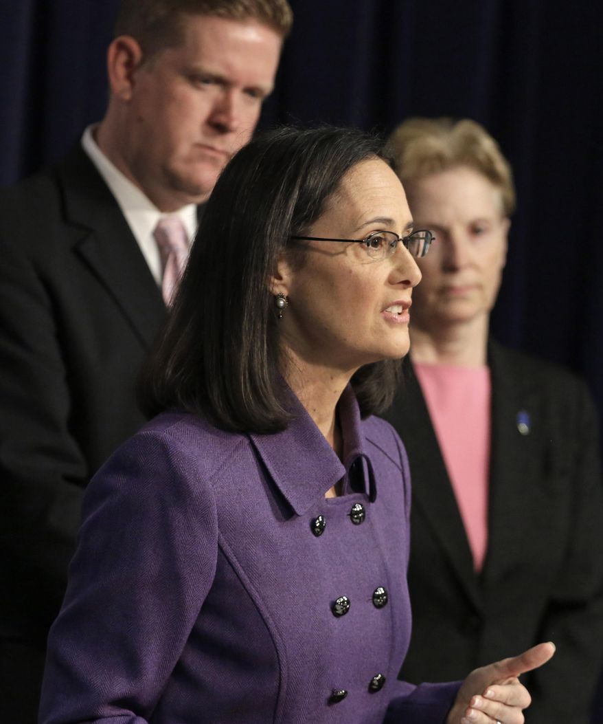 FILE - In this March 31, 2015 file photo, Illinois Attorney General Lisa Madigan, center, speaks at a news conference accompanied by St. Clair County State's Attorney Brendan Kelly, left, and Polly Poskin, Executive Director of the Illinois Coalition Against Sexual Assault in Chicago. The attorney general is continuing a statewide tour to generate support for more stringent efforts to prevent campus sex assaults. Madigan is scheduled to visit Southern Illinois University-Edwardsville on Monday, April 27, 2015 to promote a legislative proposal called the Preventing Sexual Violence in Higher Education Act. The bill would require Illinois colleges and universities to bolster existing efforts by adopting “comprehensive policies concerning sexual violence, domestic violence, dating violence and stalking.” (AP Photo/M. Spencer Green)