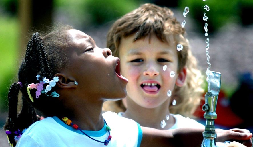 Tianna Swisher, a student at Liberty Valley Elementary School in Danville, Pa., attempts to drink from the water fountain at Montour Preserve near Washingtonville, Pa., during an outdoor field trip. (Associated Press)