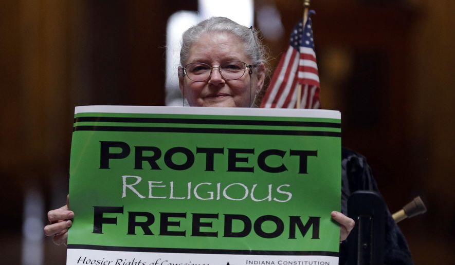 Condy Holmes of Mechanicsburg, Ind., holds a sign a rally at the Statehouse in Indianapolis, Monday, April 27, 2015, against the revised religious freedom legislation. (AP Photo/Michael Conroy) ** FILE **