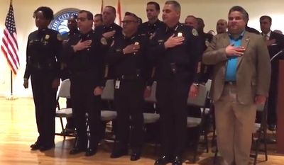 Miami&#39;s top police union representative is facing backlash from the city&#39;s oldest black police organization after he called for a reprimand against Assistant Chief of Police Anita Najiy (pictured on the far left) and questioned her Muslim faith when she failed to salute the American flag. (YouTube/Miami Herald)