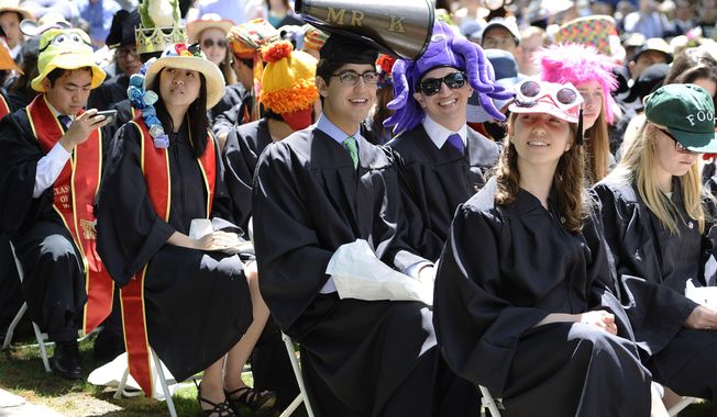 Yale University students wear a variety of head coverings during Class Day at Yale in New Haven (AP Photo/Jessica Hill)