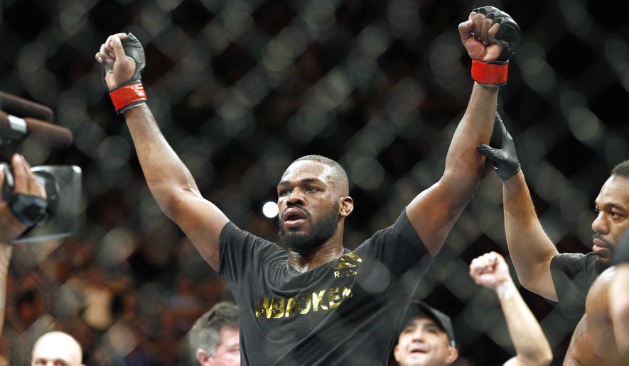 A felony arrest warrant was issued Monday for UFC light-heavyweight champion Jon &quot;Bones&quot; Jones in a hit-and-run accident that broke the arm of a pregnant woman. (Associated Press)