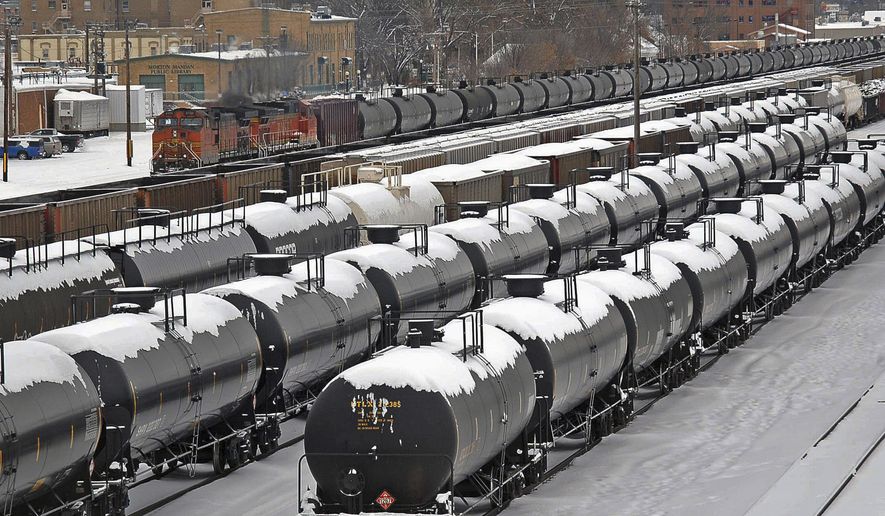 FILE - In this Dec. 31, 2013 file photo, oil cars are backed up in a yard in the aftermath of a train derailment in Mandan, N.D. North Dakota's Senate on Monday, April 27, 2015, approved funding for a state-run rail safety pilot program intended to supplement federal oversight of burgeoning oil train traffic. (Tom Stromme/The Bismarck Tribune via AP, File)