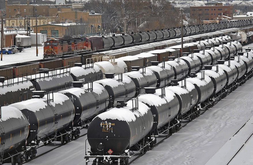 FILE - In this Dec. 31, 2013 file photo, oil cars are backed up in a yard in the aftermath of a train derailment in Mandan, N.D. North Dakota's Senate on Monday, April 27, 2015, approved funding for a state-run rail safety pilot program intended to supplement federal oversight of burgeoning oil train traffic. (Tom Stromme/The Bismarck Tribune via AP, File)