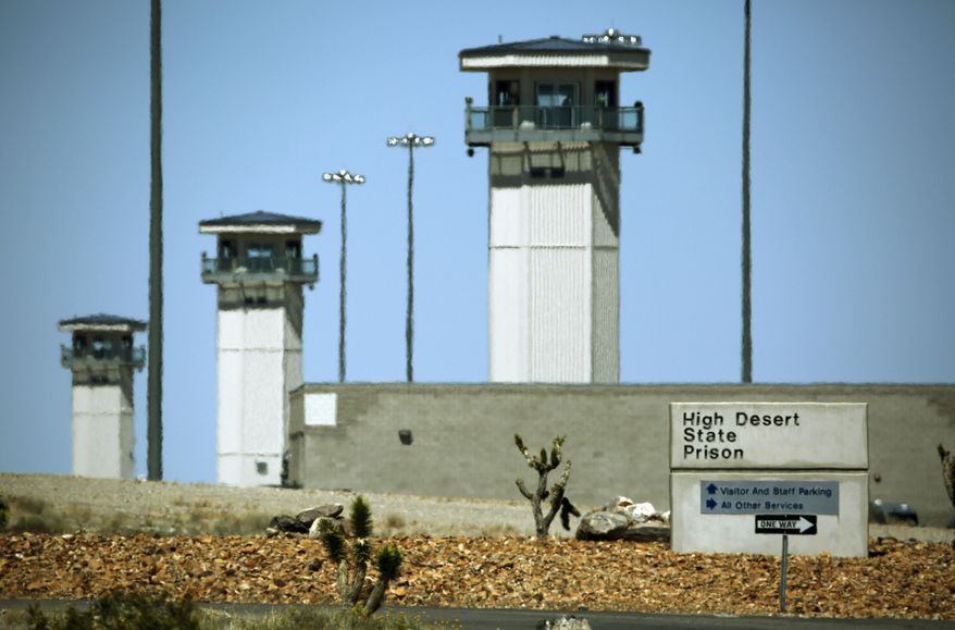 FILE - This April 15, 2015 file photo shows guard towers at High Desert State Prison in Indian Springs, Nev., one of Nevada’s toughest prisons. Attorneys for two inmates involved in a deadly prison brawl are accusing prison guards of instigating the fight to set up a gladiator-style contest and then trying to cover it up by blaming the surviving prisoner. (AP Photo/John Locher, File)