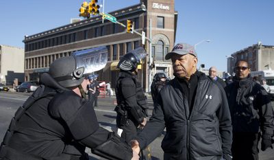 U.S. Rep. Elijah Cummings, D-Md., shakes hands with a Maryland State Trooper Tuesday, April 28, 2015, in the aftermath of rioting following Monday&#39;s funeral for Freddie Gray, who died in police custody. (AP Photo/Matt Rourke) ** FILE **