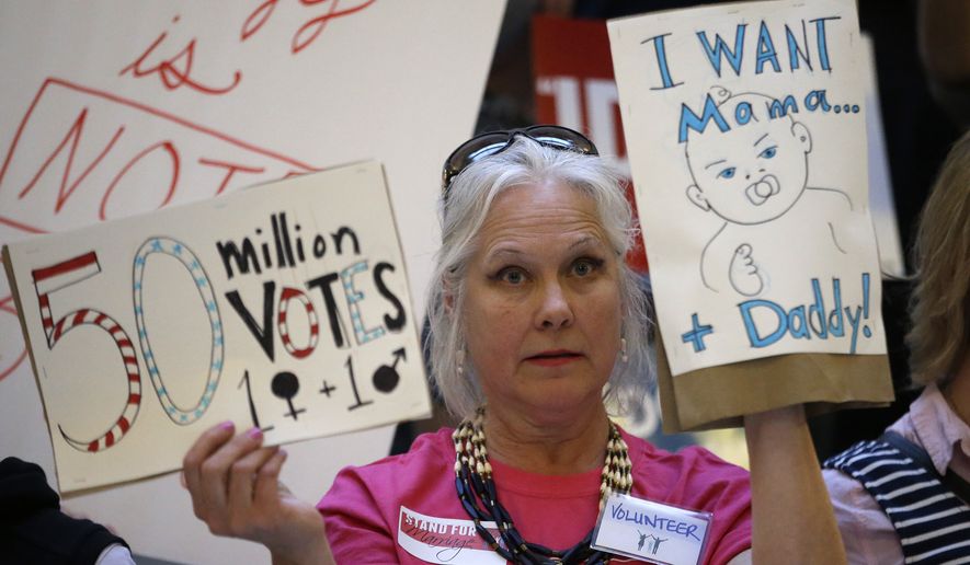 Joani Allen, an opponent of same-sex marriage, holds a sign during a rally at the Utah State Capitol Tuesday, April 28, 2015, in Salt Lake City. Supporters and opponents of same-sex marriage rallied in Utah on Tuesday after the U.S. Supreme Court heard arguments on the constitutionality of laws banning such marriages. (AP Photo/Rick Bowmer)
