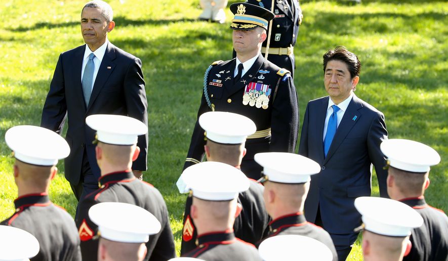 President Barack Obama and Japanese Prime Minister Shinzo Abe review the troops on the South Lawn of the White House in Washington, Tuesday, April 28, 2015, during a state arrival ceremony. (AP Photo/Andrew Harnik)