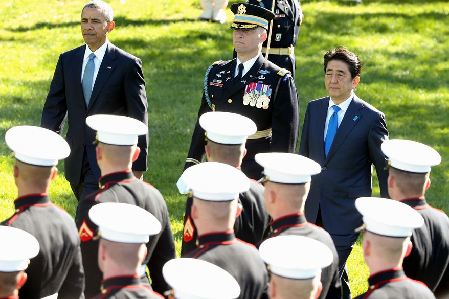President Barack Obama and Japanese Prime Minister Shinzo Abe review the troops on the South Lawn of the White House in Washington, Tuesday, April 28, 2015, during a state arrival ceremony. (AP Photo/Andrew Harnik)