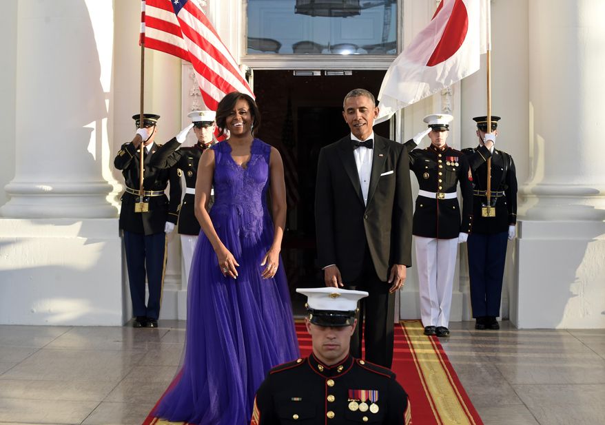 President Barack Obama and first lady Michelle Obama welcome wait for the arrival of Japanese Prime Minister Shinzo Abe and his wile Akie Abe at the North Portico of the White House in Washington for a State Dinner, Tuesday, April 28, 2015. (AP Photo/Susan Walsh)