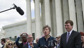 Civil rights lawyer Mary Bonautu, center, flanked by plaintiff James Obergefell of Ohio, left, and Washington attorney Douglas Hallward-Driemeier, right, speaks outside the Supreme Court in Washington, Tuesday , April 28, 2015, following a hearing on same-sex marriage. (AP Photo/Cliff Owen)
