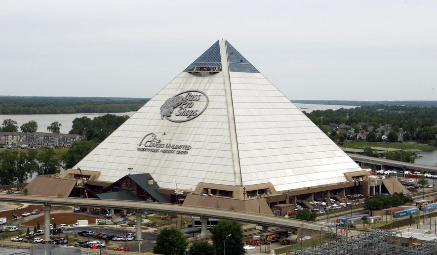In this April 27, 2015 photo, the new Bass Pro Shop store stands near the Mississippi River in Memphis, Tenn. The store, which opens April 29, is in the Memphis landmark known as the Pyramid. Bass Pro and the city agreed on a 55-year-lease in 2010, and construction to convert the 535,000-square foot building from arena to megastore began four years ago. (AP Photo/Karen Pulfer Focht)