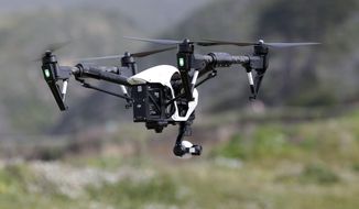 FILE - In this March 10, 2015 file photo, The Inspire 1, a drone manufactured by DJI, is flown in Davenport, Calif. Mexico published rules governing the use of drones on Wednesday, April 29, 2015, allowing people to operate the smallest drones in daylight without a permit but with safety rules. (AP Photo/Marcio Jose Sanchez, File)
