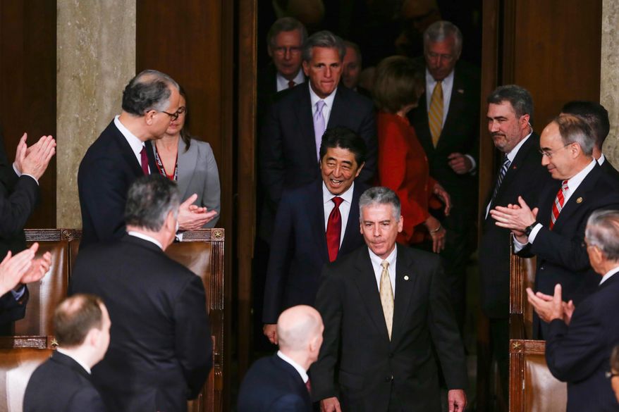 Japanese Prime Minister Shinzo Abe, accompanied by Congressional leadership, arrives on Capitol Hill in Washington, Wednesday, April 29, 2015, to speak before a joint meeting of Congress. (AP Photo/Carolyn Kaster)