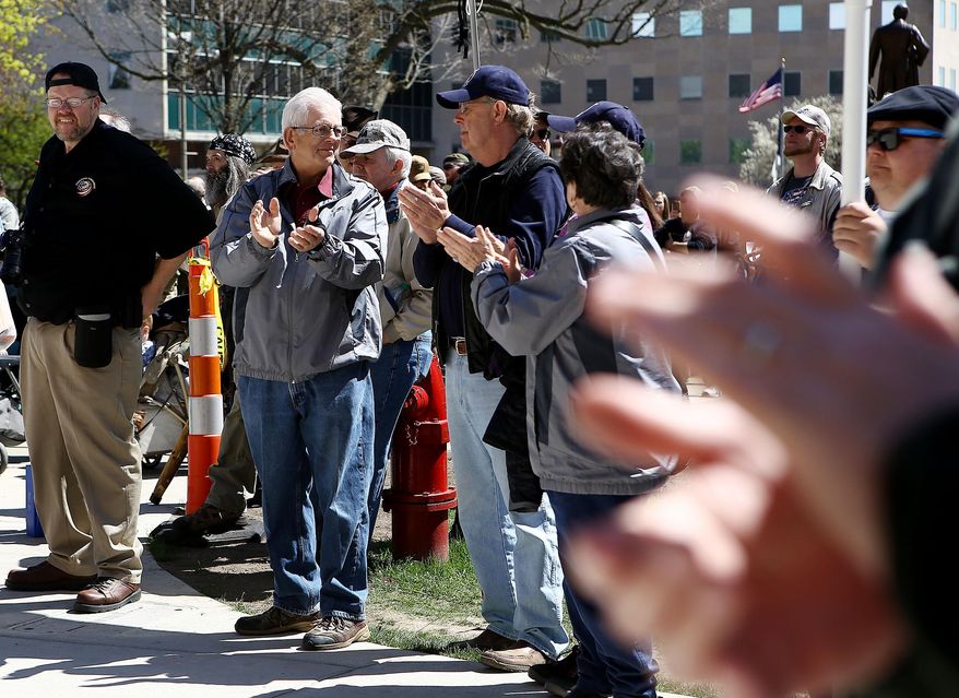 Gun owners and supporters listen to state Rep. speak Gary Glenn during an open carry gun rally and march Wednesday, April 29, 2015, in downtown Lansing, Mich. (Danielle Duval/The Jackson Citizen Patriot via AP) ALL LOCAL TELEVISION OUT; LOCAL TELEVISION INTERNET OUT