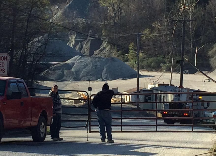 People stand at the the entrance to the Whitney Stone Quarry in Unity Township Pa., Wednesday, April 29, 2015, where three people were injured in an accident. Two of those hurt were flown to Pittsburgh hospitals with serious injuries while a third was taken to another hospital by ambulance. (Darrell Sapp/Pittsburgh Post-Gazette via AP) TV OUT: MAGS OUT; NO SALES; MONESSEN OUT; KITTANNING OUT; CONNELLSVILLE OUT; GREENSBURG OUT; TARENTUM OUT; NORTH HILLS NEWS RECORD OUT; BUTLER OUT
