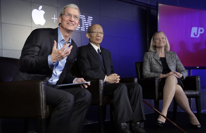 Apple CEO Tim Cook, left, addresses a news conference, joined by Japan Post CEO Taizo Nishimuro, and IBM CEO Ginni Rometty, at IBM Watson headquarters, in New York, Thursday, April 30, 2015. Apple, IBM and Japanese insurance and bank holding company Japan Post have formed a partnership to improve the lives of elderly people in the country. The program will provide iPads with apps designed to help seniors manage day-to-day lives and keep in touch with family members. (AP Photo/Richard Drew)