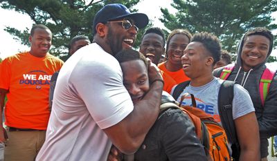 Former Baltimore Ravens NFL football player Ray Lewis hugs 17-year-old Azariah Bratton-Bey Jr., a senior running back on Frederick Douglass High&#x27;s football team, during a visit to the school Thursday, April 30, 2015, in Baltimore. Lewis, Ravens coach John Harbaugh, and other players visited schools in downtown Baltimore in the aftermath of riots that ravaged the city. (Kenneth K. Lam/Baltimore Sun via AP) THE WASHINGTON EXAMINER OUT