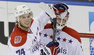 Washington Capitals defenseman John Carlson (74) congratulates goalie Braden Holtby (70) after the Capitals defeated the New York Rangers 2-1 in Game 1 of the second round of the NHL Stanley Cup hockey playoffs Thursday, April 30, 2015, in New York. (AP Photo/Frank Franklin II)