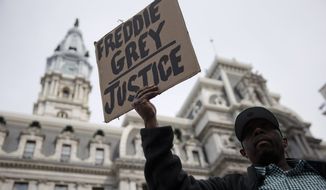 Daniel H. Smith demonstrates outside City Hall in Philadelphia on Thursday. The event in Philadelphia follows days of unrest in Baltimore amid Freddie Gray&#39;s police-custody death. (Associated Press)